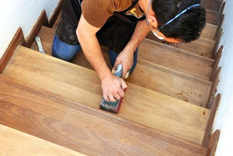 carpenter sanding a floor