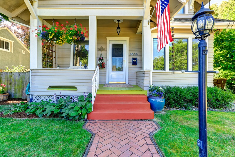 American flag hanging in front of entrance to a home