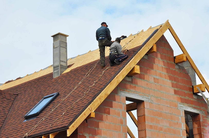 roof being installed by two men