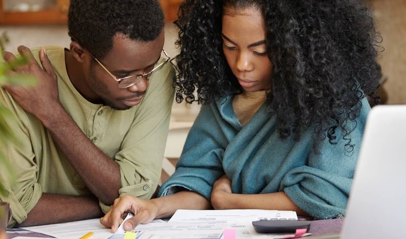 black couple looking at papers