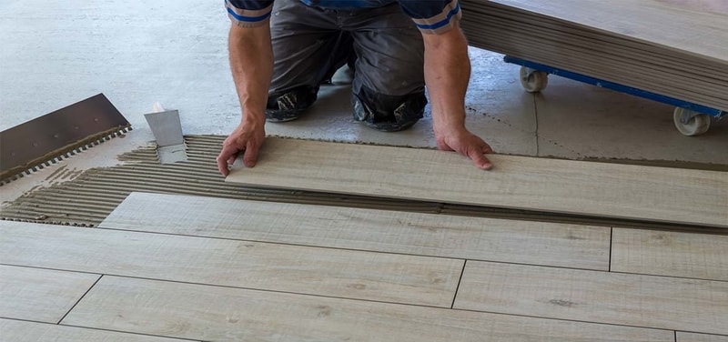 wood look tile being installed