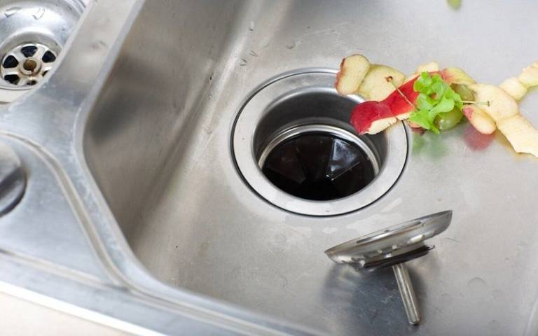 my kitchen sink backs up but garbage disposal unclogs